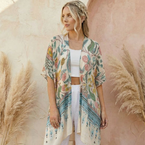 Woman wearing a Soulza floral kimono in front of pampas grass