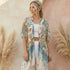 Woman wearing a Soulza floral kimono in front of pampas grass