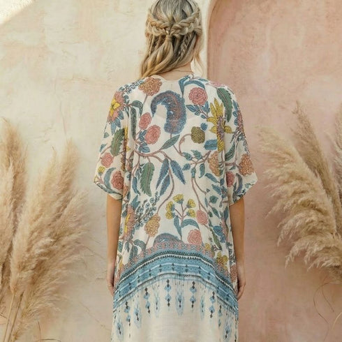 Woman wearing a Soulza Pink Floral Kimono standing among pampas grass with a blurred background