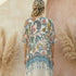 Woman wearing a Soulza Pink Floral Kimono standing among pampas grass with a blurred background