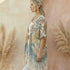 Woman wearing a Soulza floral kimono standing among pampas grass with a blurred background